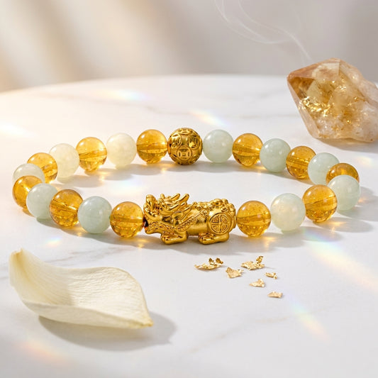 Bracelet with gold dragon charm and colored beads on a white surface